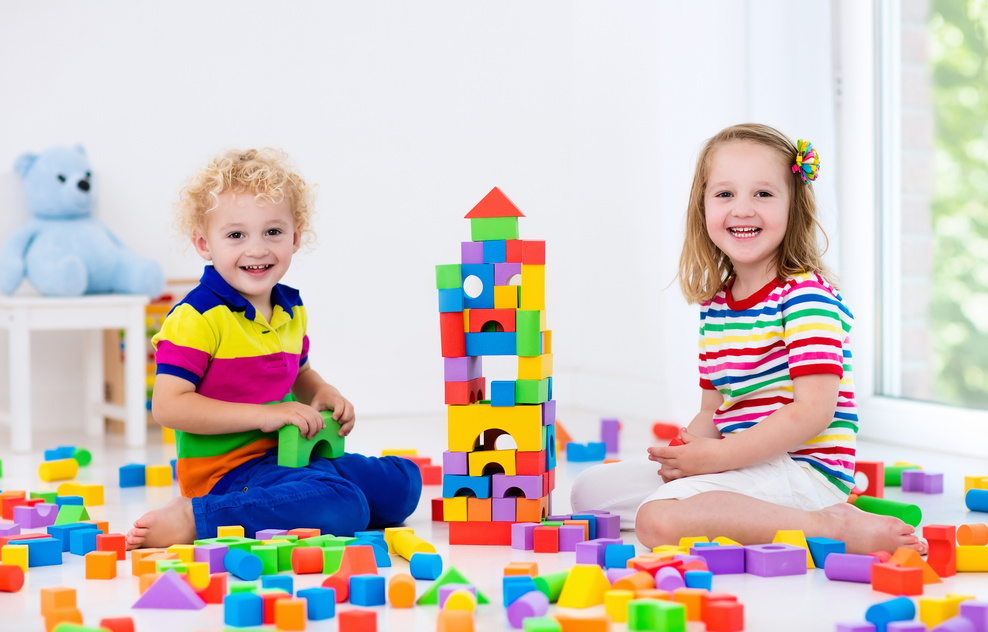 Kids playing with colorful plastic toy blocks